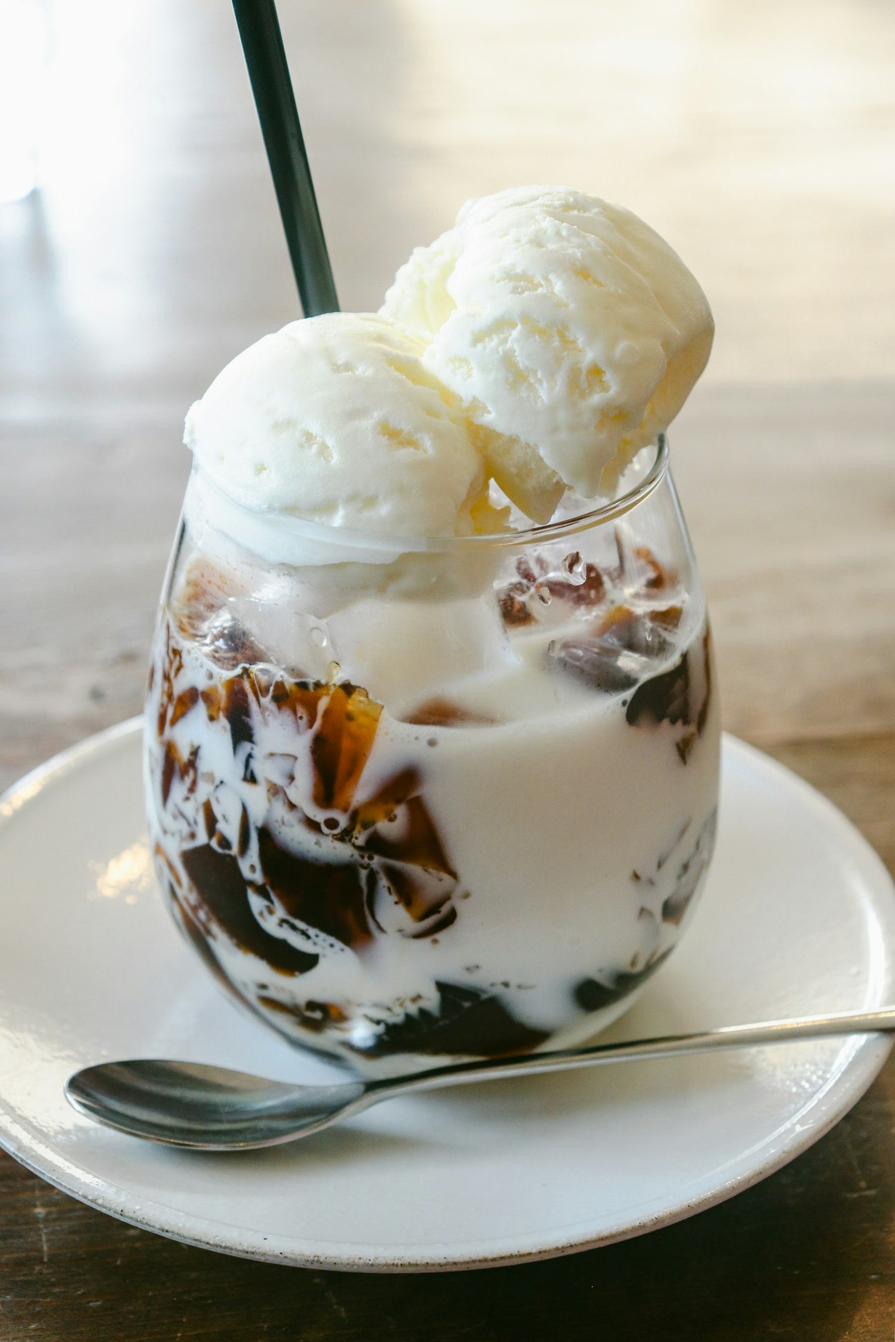 Espresso poured over vanilla ice cream in a glass
