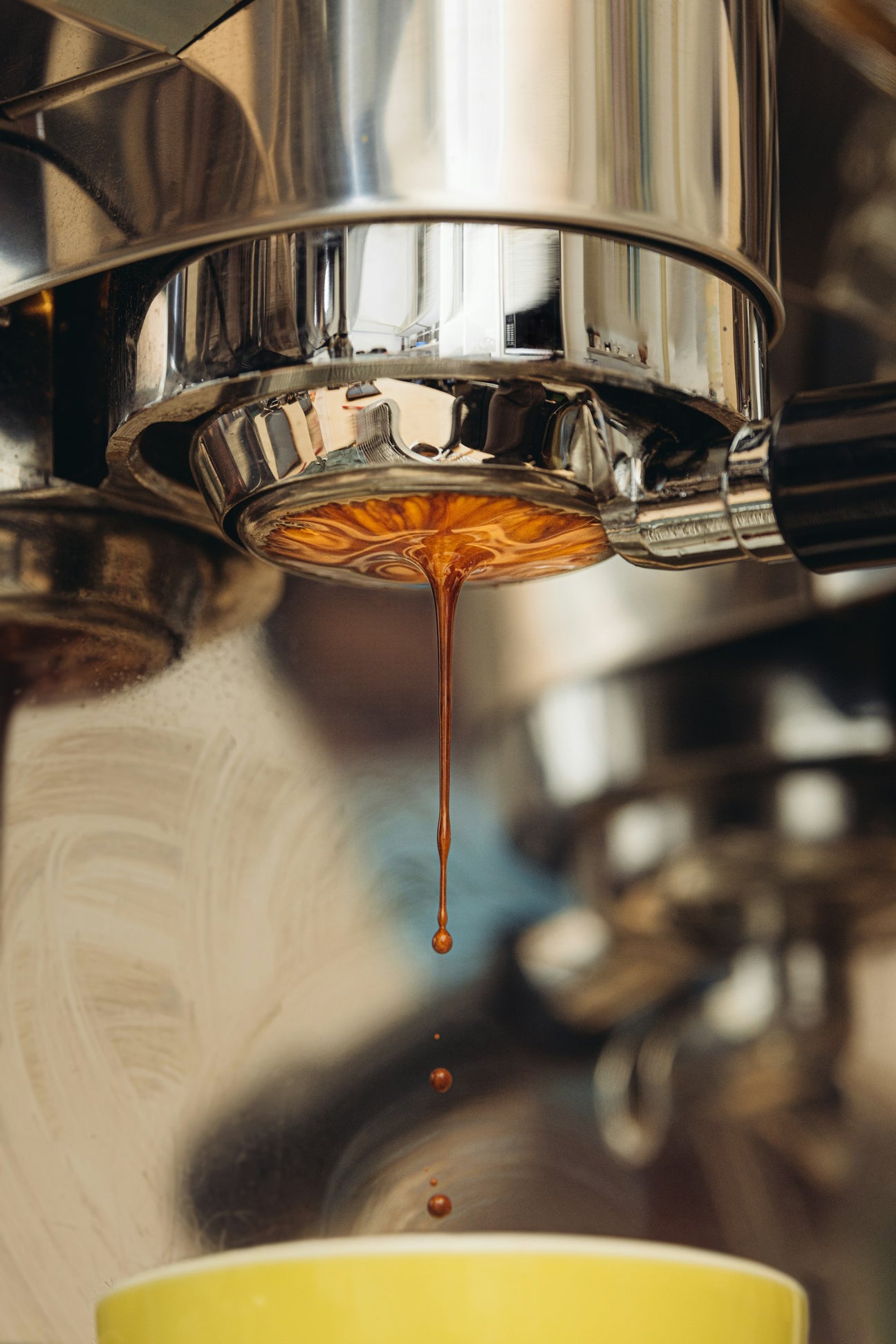 Espresso dripping from a naked portafilter