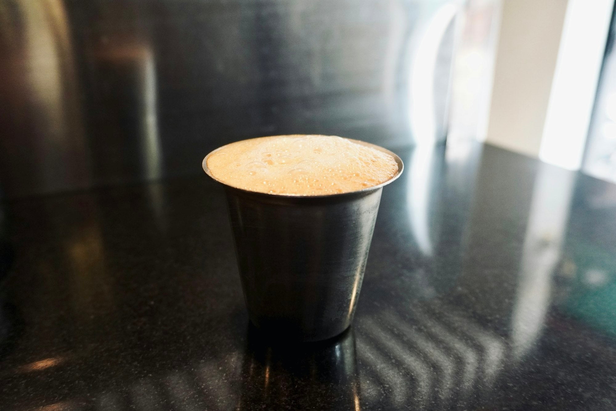 Dark filter coffee in a steel tumbler
