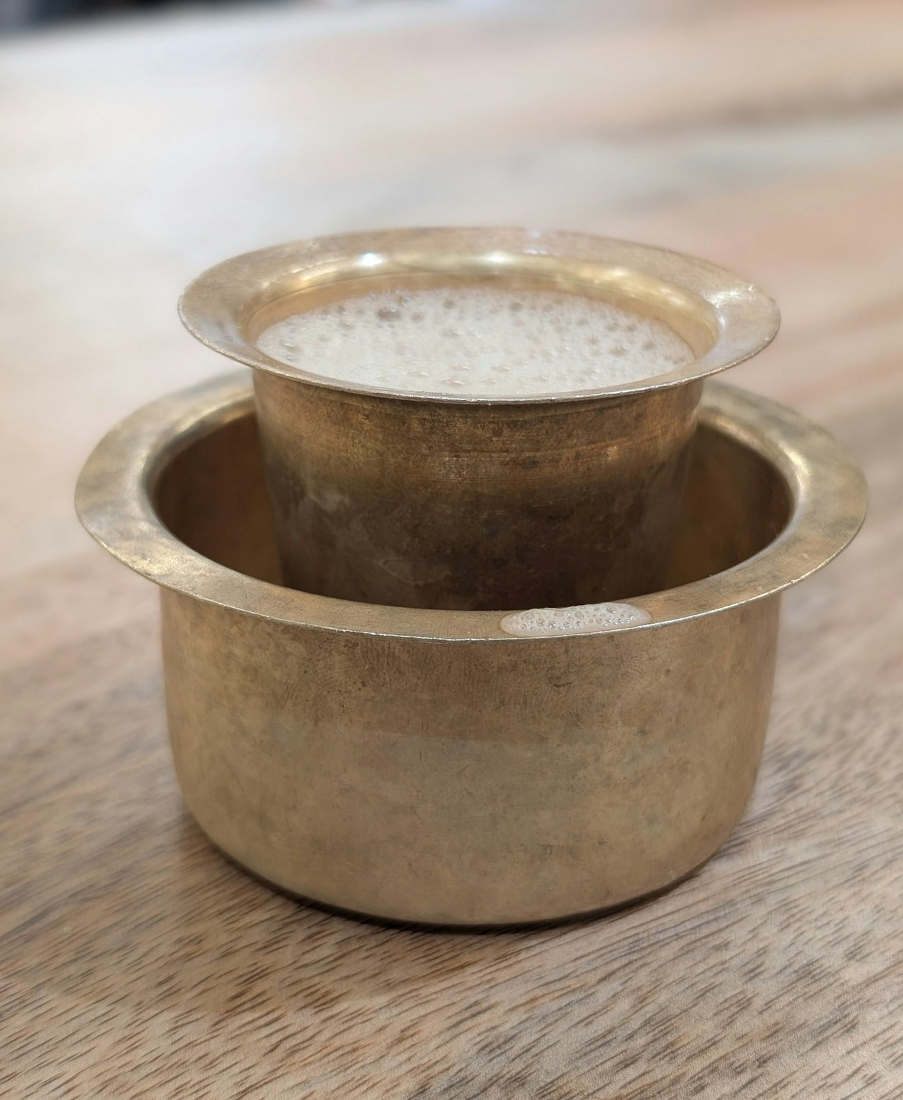 A traditional brass South Indian filter coffee davara and tumbler