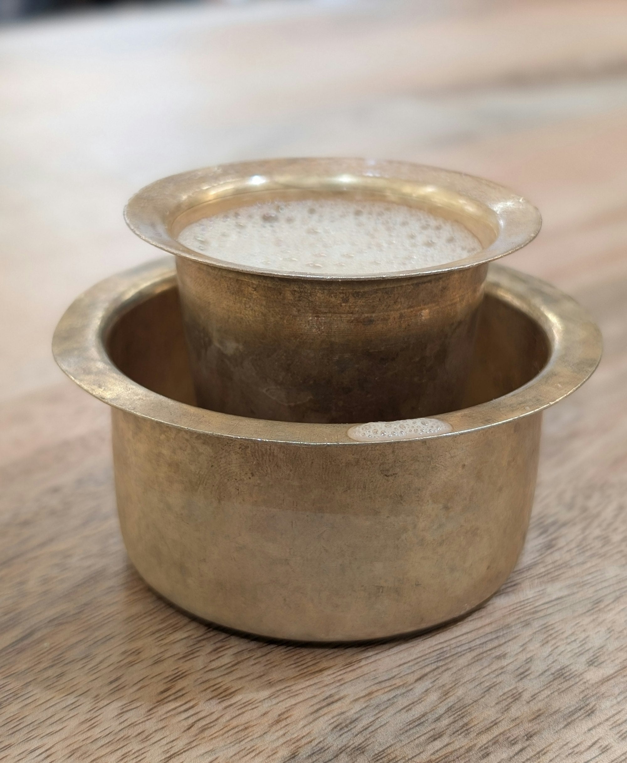 A traditional brass South Indian filter coffee davara and tumbler