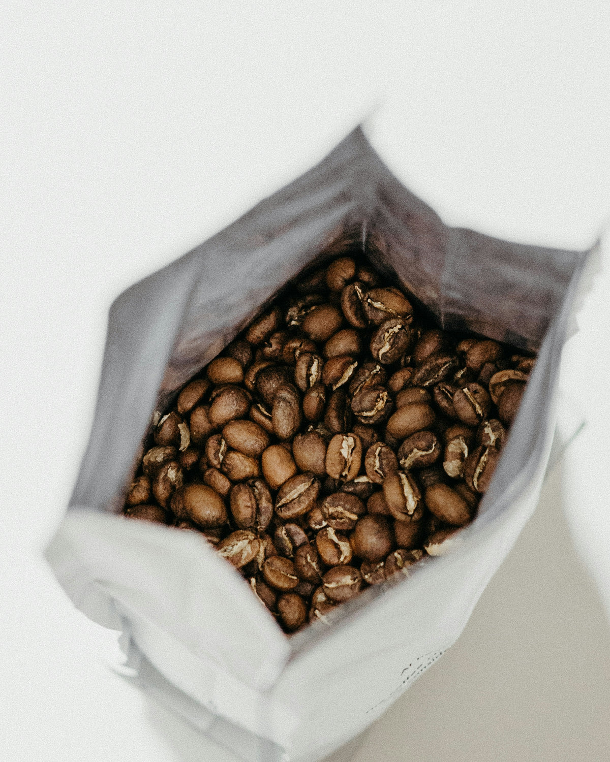 THE STANDARD subscription from BROOT, an open bag of freshly roasted whole coffee beans